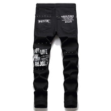 Lade das Bild in den Galerie-Viewer, Men's Scotland Red Plaid Tartan Patchwork Jeans Punk Rivet Patch Black Denim Pants Skull Letters Printed Slim Straight Trousers