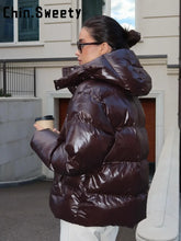 Load image into Gallery viewer, Fashion Shiny Solid Hooded Quilted Jacket Women Stand Collar Long Sleeve Zipper Pocket Street Warm Coat 2026 Winter Lady Outwear
