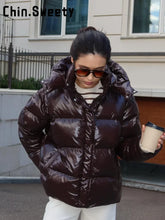 Load image into Gallery viewer, Fashion Shiny Solid Hooded Quilted Jacket Women Stand Collar Long Sleeve Zipper Pocket Street Warm Coat 2026 Winter Lady Outwear
