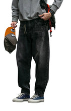 Load image into Gallery viewer, SHADOW FASHION CLOTHING men's loose-fit black denim harem pants with a casual streetwear style and button fly closure.
