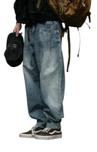 Load image into Gallery viewer, SHADOW FASHION CLOTHING men's loose-fit denim harem pants in a light blue wash, styled for a casual streetwear look.
