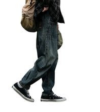 Load image into Gallery viewer, SHADOW FASHION CLOTHING men's loose denim harem pants in a vintage blue wash, styled for a casual streetwear look.
