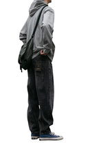 Load image into Gallery viewer, SHADOW FASHION CLOTHING men wearing loose grey denim harem pants with a grey hoodie and blue sneakers in a casual setting
